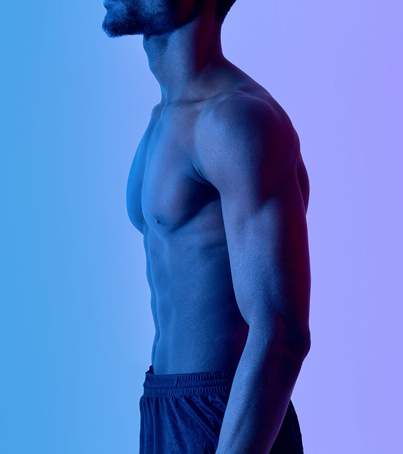 Fit man under a blue light