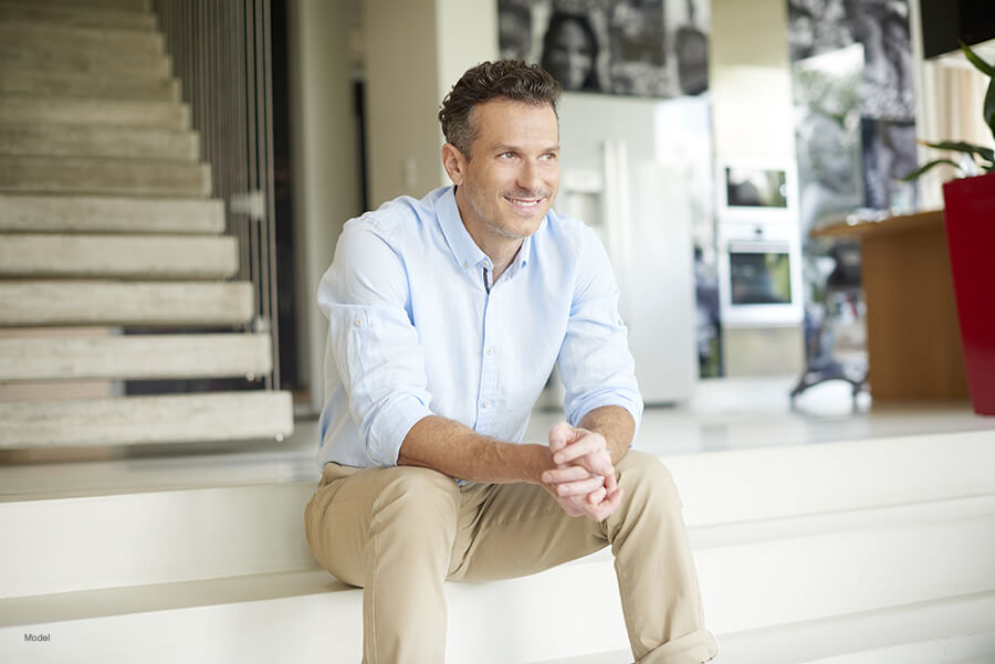 man sitting on a stairwell smiling